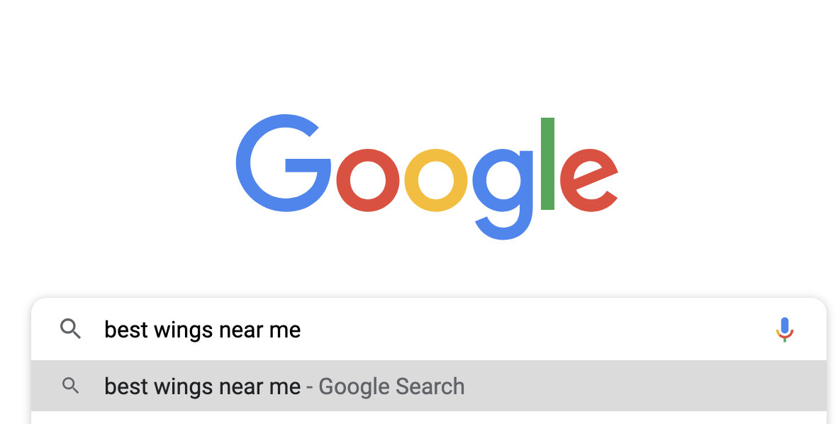 image of Google search bar with "best wings near me" typed in