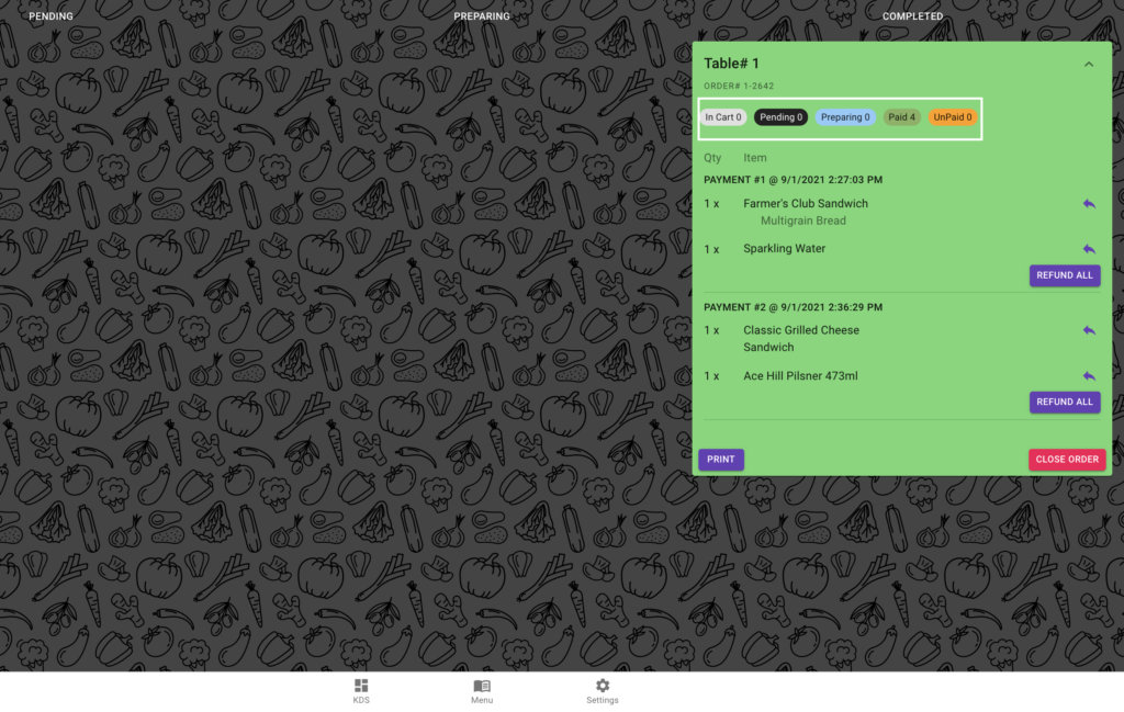 OrderUp KDS showing a fully paid table in green