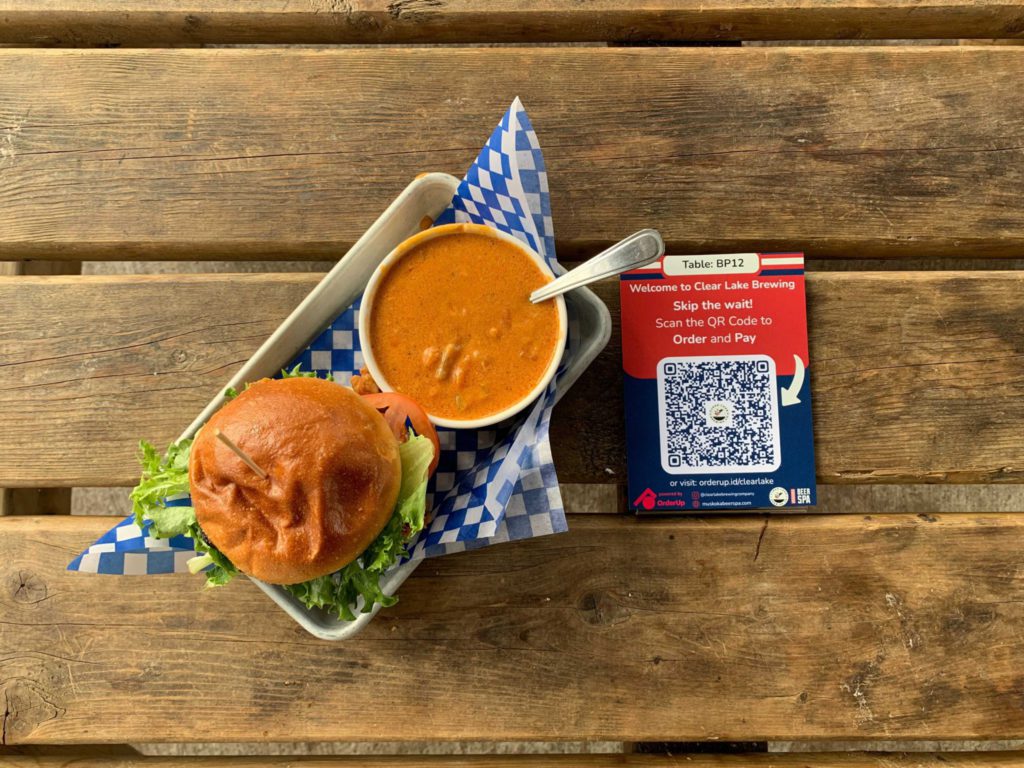 Burger and a soup beside a qr code, qr code ordering for restaurants is a restaurant trend for 2023