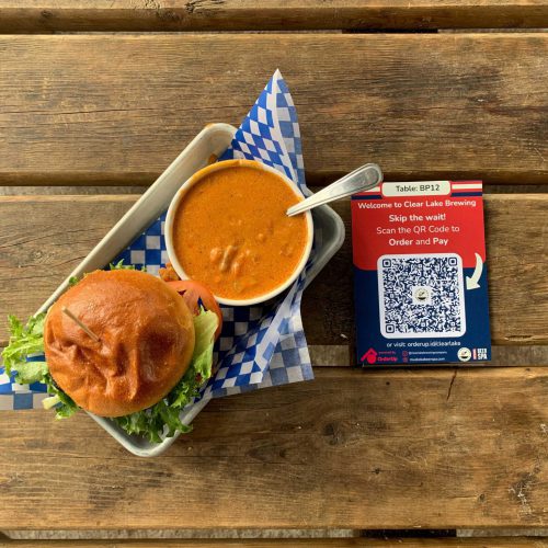 Burger and a soup beside a qr code, qr code ordering for restaurants is a restaurant trend for 2023